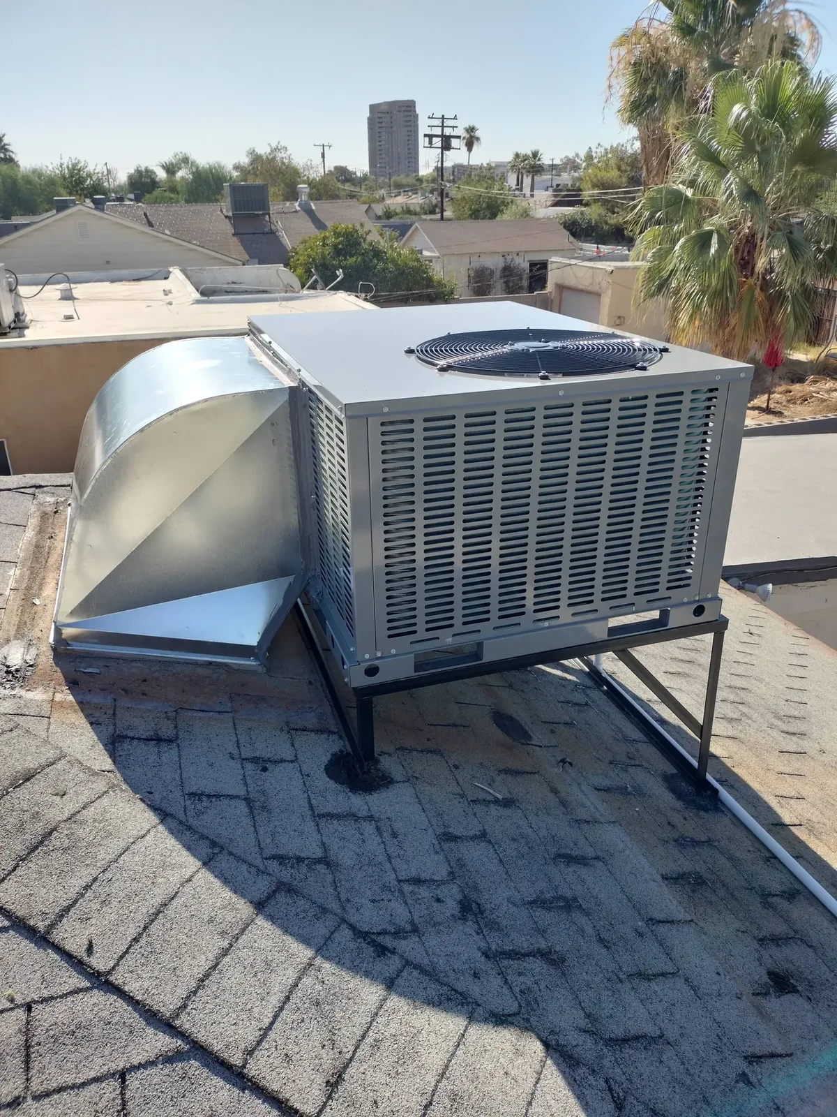 Rooftop packaged A/C unit with new sheet-metal ductwork on a Phoenix home