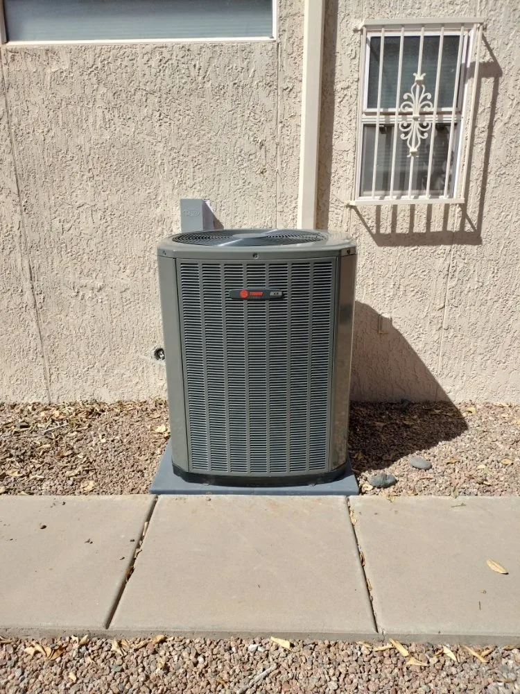 New Trane split-system A/C condenser installed beside a Phoenix home